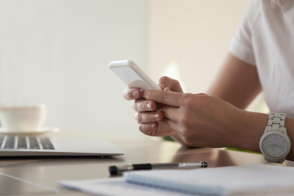 businesswoman-looking-important-contact-on-phone-1024x683
